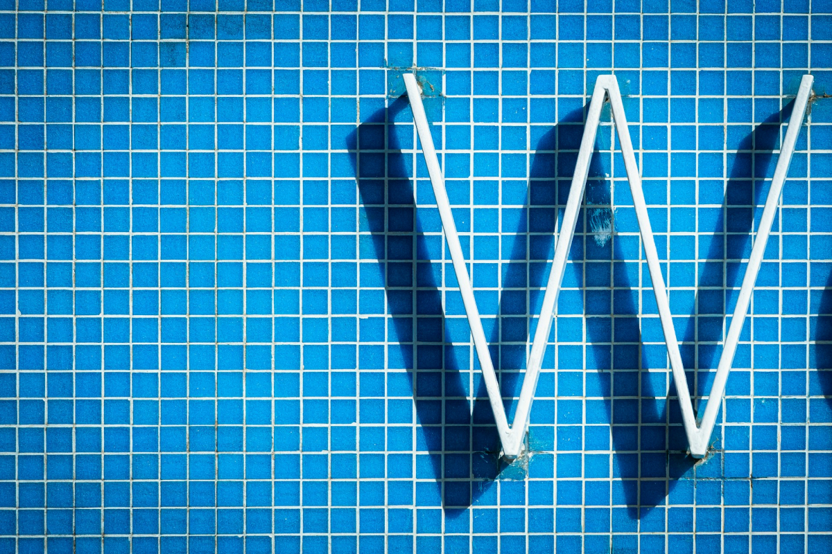 letter W on blue tiles wall
